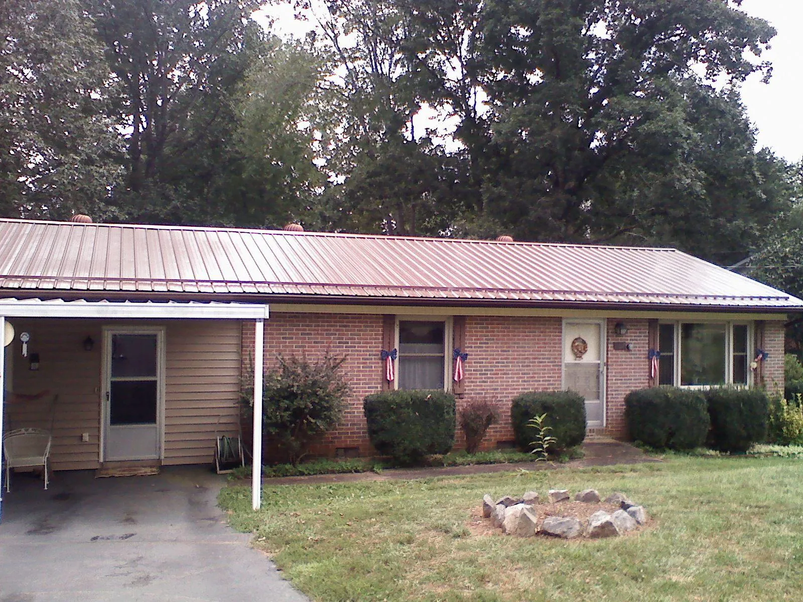 Bronze metal roof and carport on a brick ranch home — Roof Repair work by our crew in Minersville