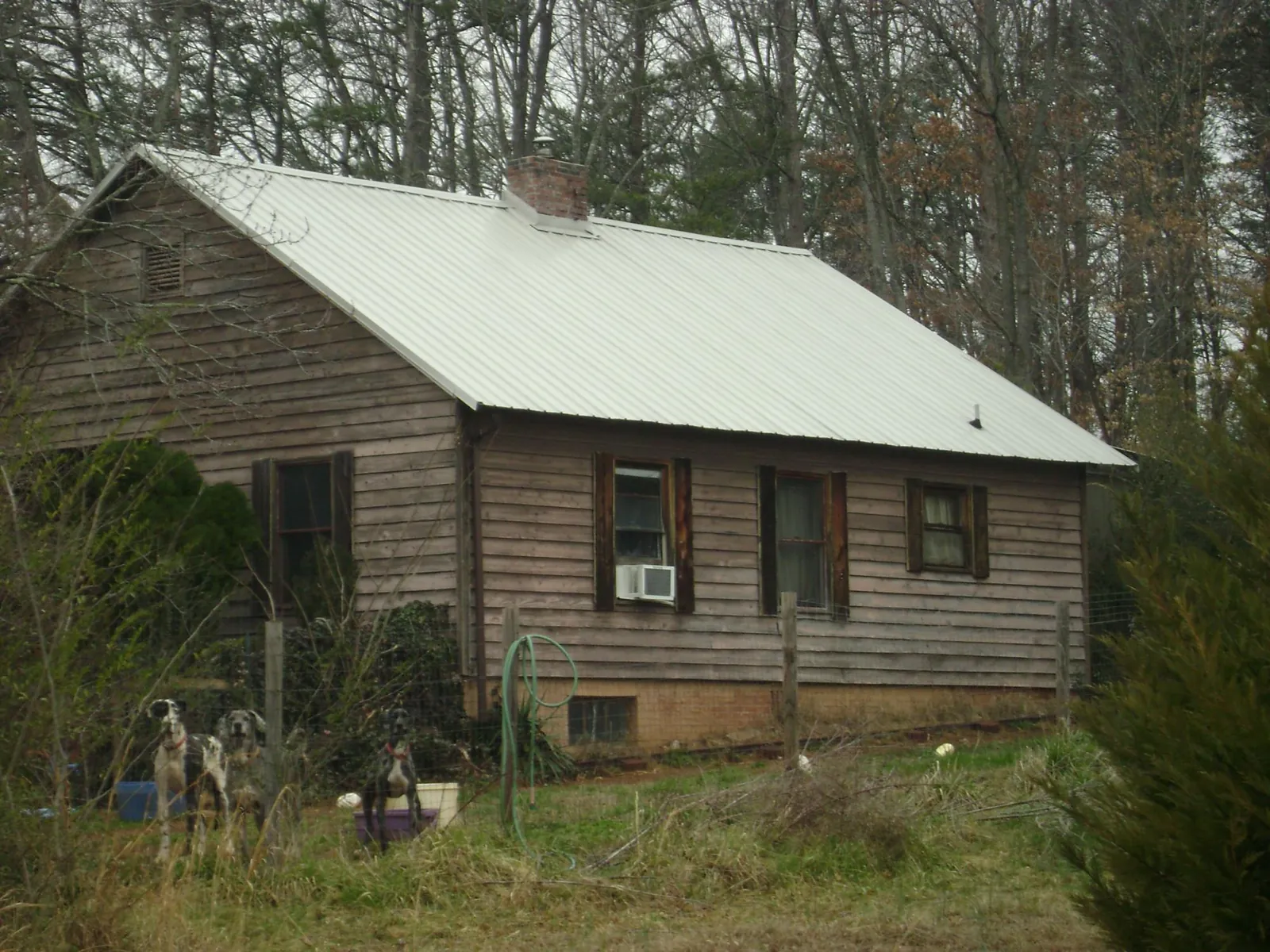 White metal roof on an old wood sided farmhouse, from a Metal Roof Installation job in Minersville